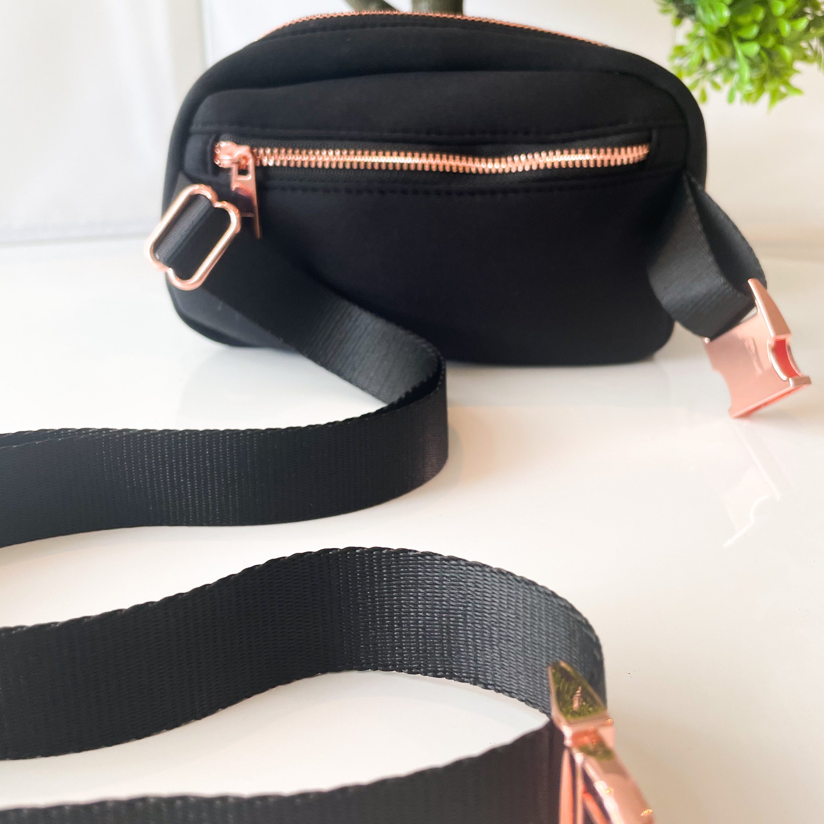 A stylish New Black Walkies Bag designed for dog parents, featuring rose gold hardware and adjustable straps.